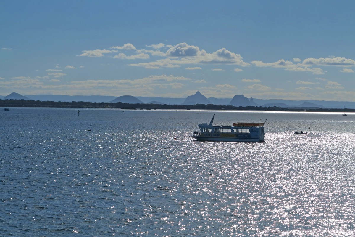 Sun on the water of Pumicestone Passage, looking over to Glass House Mountains